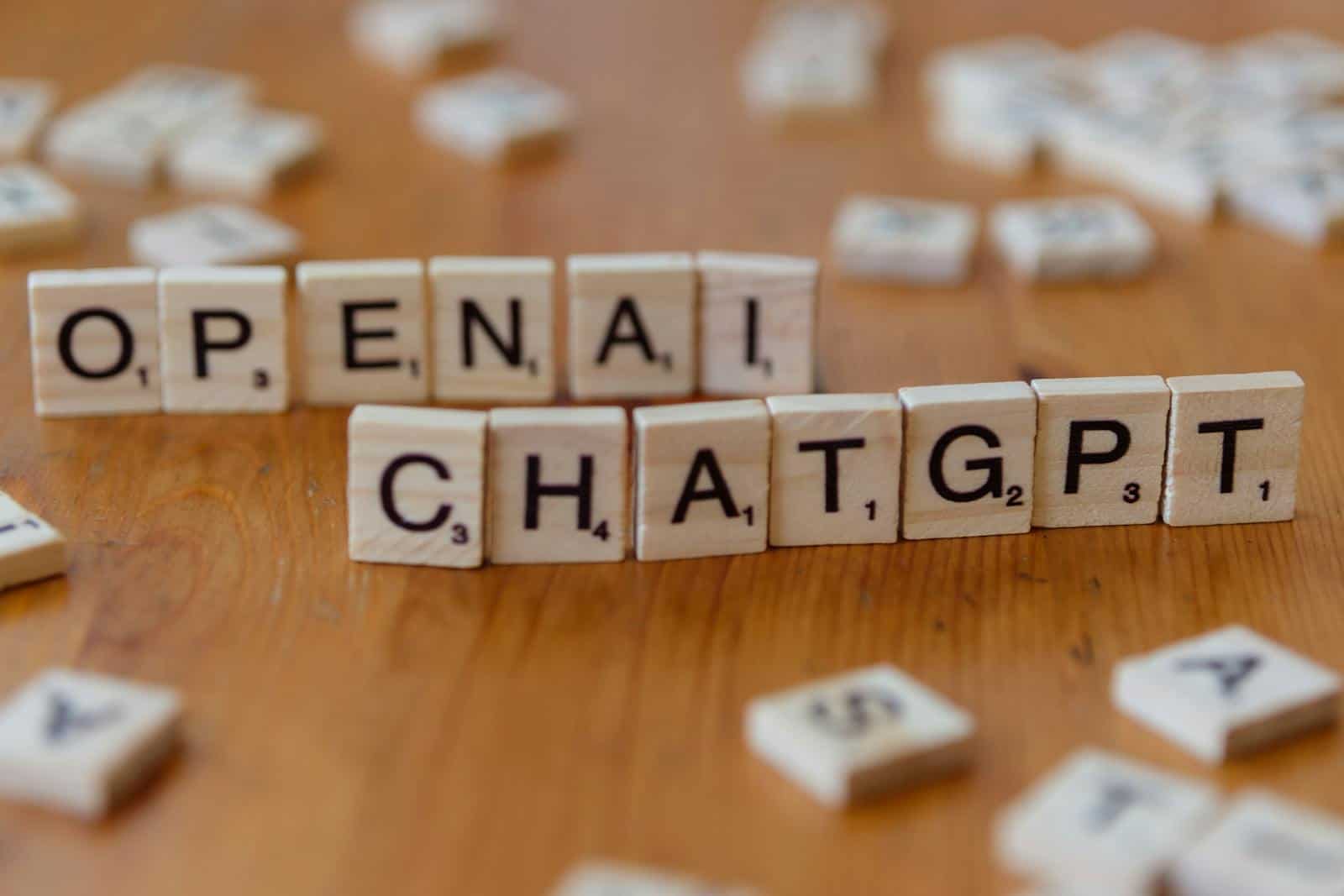 Open chat message tiles with words "OPEN" and "CHAT" on a wooden table.