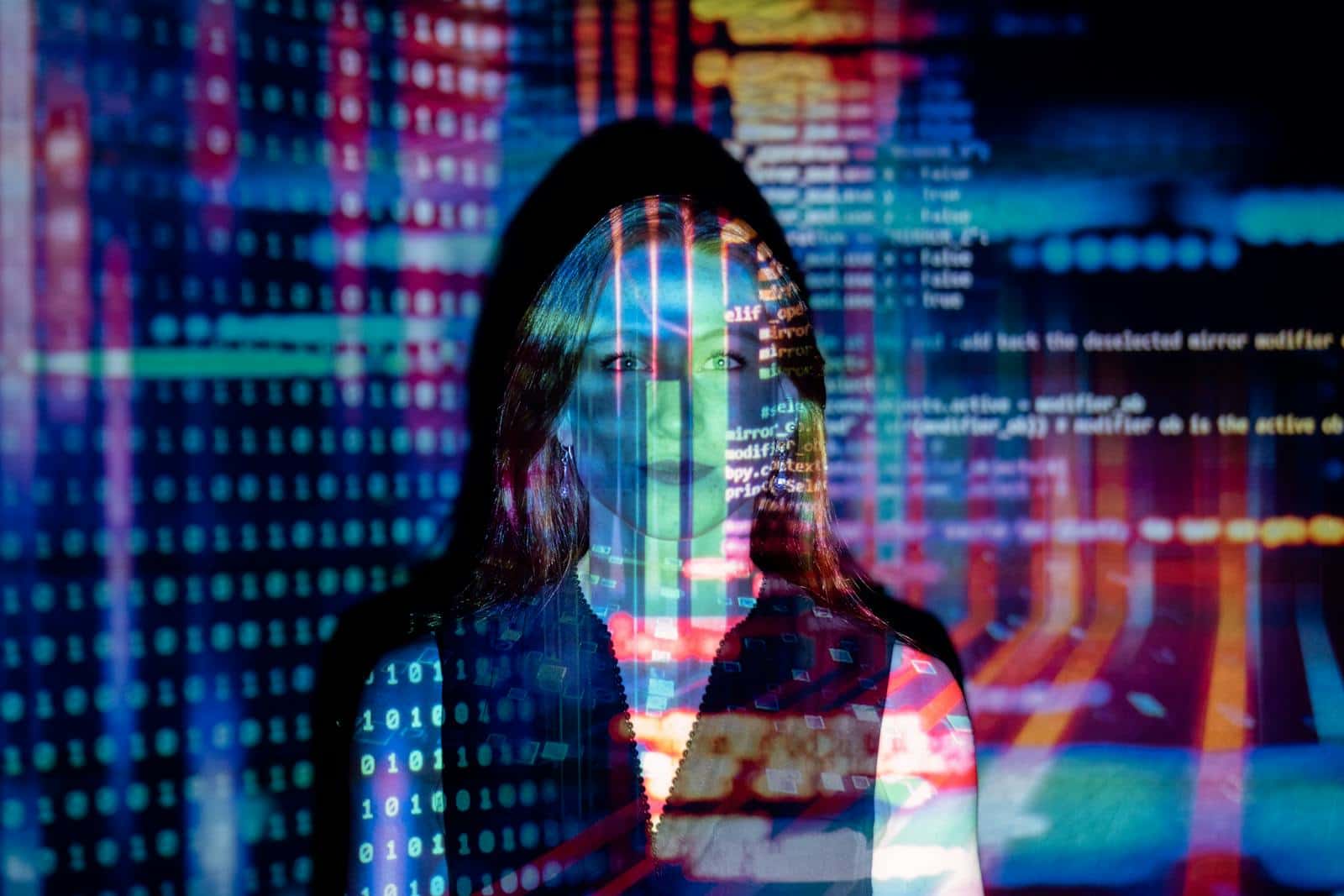 Digital technology and programming concepts with a woman and colorful code background.